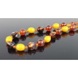 A faux amber beaded necklace; together with a pair of modern 9ct gold and sapphire set ear