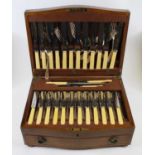 An early 20th century oak cased canteen of silver plated cutlery in the Hanoverian pattern