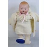 A vintage bisque headed doll, impressed Kammer and Reinhardt for Simon & Halbig to the neck,