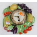 A German pottery wall clock, relief decorated with fruit, h.28cm
