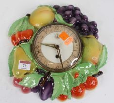 A German pottery wall clock, relief decorated with fruit, h.28cm