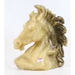 A carved hardstone horse's head, h.34cm Appears intact but surface is flaky.