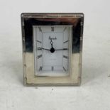 An Elizabeth II silver clad desk clock, the painted dial signed Harrods, having a quartz movement,