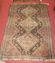 A Persian woollen Tabriz rug, having a lozenge floral central ground within tramline borders (worn