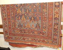 A Persian red and blue ground Tabriz rug, with geometric floral stylised decoration to trailing