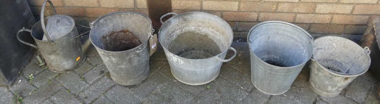 A collection of four various galvanised metal buckets, together with a similar watering can (5)