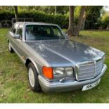 A 1988 Mercedes Benz 420SE in metallic grey Registration RNJ 44 (Note that this private registration