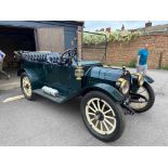 A 1913 Empire Little Aristocrat four-door convertible saloon in green. Registration No. SV 4041