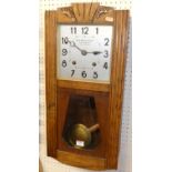 An Art Deco oak drop trunk wall clock, by Billard-Volteau, with pendulum and winding key, height