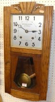 An Art Deco oak drop trunk wall clock, by Billard-Volteau, with pendulum and winding key, height