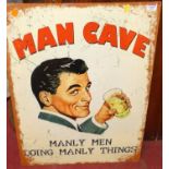 A printed tin sign 'Man cave', 70 x 50cm