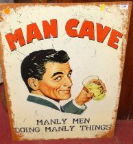 A printed tin sign 'Man cave', 70 x 50cm