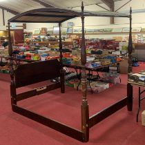 A contemporary mahogany kingsize full tester bed, having a slightly curved canopy, raised on