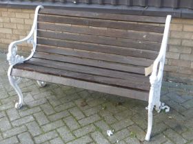 A white painted cast and pierced metal ended slatted teak two-seater garden bench, width 128cm