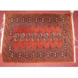 A small Persian red ground woollen Bokhara hall mat, 90 x 65cm