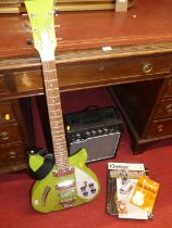 An electric guitar with amplifier, and various magazines