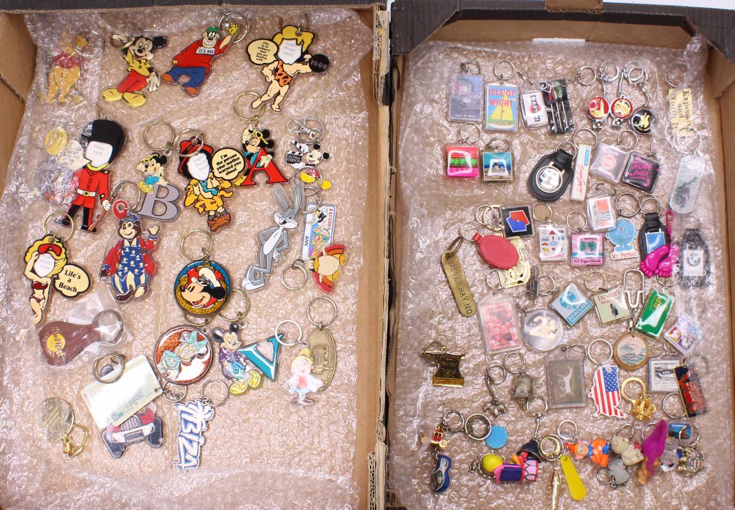Three trays of Around the World keyrings, to include Isle of Wight, Mickey Mouse, Disneyland, etc