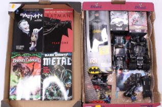 Two trays containing a quantity of Bat Man related collectables to include Lego, graphic novels, Hot