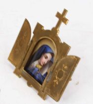 A continental icon, the central bow-ront porcelain panel depicting the Madonna within a brass
