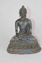 A bronzed metal and cloisonne figure of a seated Buddha, h.21cm Crack to the neck and one wrist.