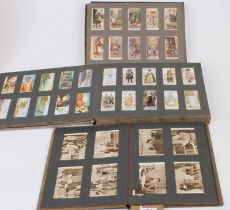 Three cigarette card albums and contents to include Players