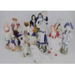 A collection of Victorian Staffordshire figures, to include spill-holders; together with continental