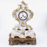 A 19th century French porcelain mantel clock, the enamelled dial showing Roman numerals, having
