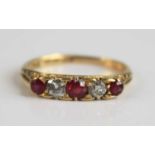 An early 20th century 18ct yellow gold, ruby and diamond half hoop ring, comprising three