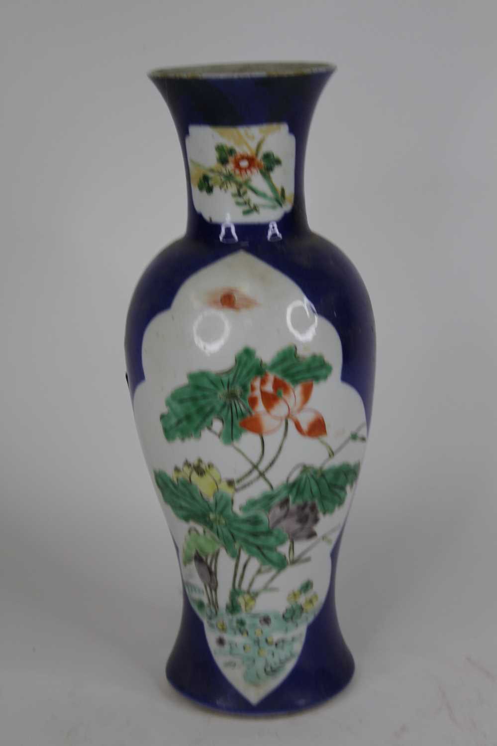 A Chinese porcelain vase, of baluster shape, enamel decorated with chrysanthemums within a shaped