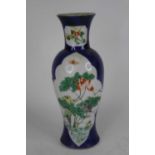 A Chinese porcelain vase, of baluster shape, enamel decorated with chrysanthemums within a shaped