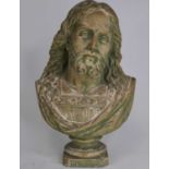 A painted pottery head and shoulders bust of Christ, h.32cm cracks to each side of the plinth