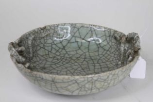 A Chinese celadon crackle glazed bowl, with moulded high relief Chi dragon decoration, dia.24cm (a/