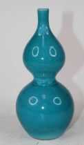 A Chinese turquoise glazed double gourd porcelain vase, bearing four character mark to the