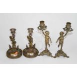 A pair of figural brass table candlesticks, h.23cm; together with another pair in the form of