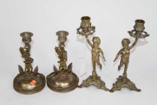 A pair of figural brass table candlesticks, h.23cm; together with another pair in the form of