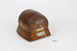 An early 20th century oak music box in the form of a barrel, height 13cm Box winds and plays as it