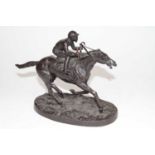 A bronze figure of a mounted jockey, on an oval naturalistic base, h.20cm