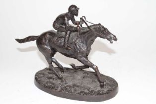 A bronze figure of a mounted jockey, on an oval naturalistic base, h.20cm