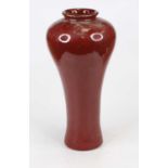 A large stoneware vase, of shouldered baluster form to a tapered body, with underglaze red