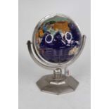 A lacquered hardstone inset terrestrial table globe on a chromed octagonal base, height 35cm