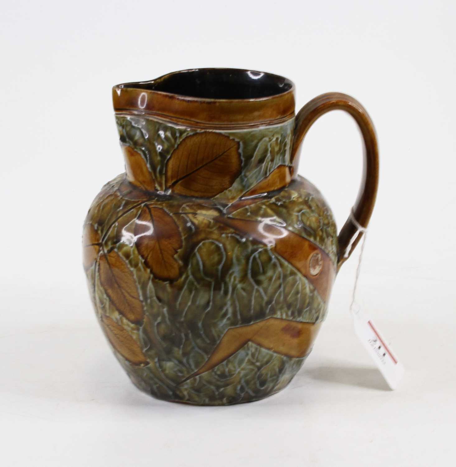 A Doulton Lambeth stoneware jug, relief decorated with foliage, numbered 9184, height 16cm