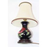 A Moorcroft pottery table lamp, tube-line decorated in the Anemone pattern, h.36cm (including