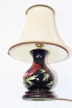 A Moorcroft pottery table lamp, tube-line decorated in the Anemone pattern, h.36cm (including