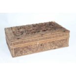 An eastern carved hardwood table cigarette box, the hinged lid opening to reveal a fitted