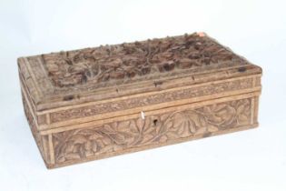 An eastern carved hardwood table cigarette box, the hinged lid opening to reveal a fitted