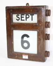 An early 20th century mahogany cased perpetual wall calendar, 30 x 24cm Linen rolls work and