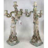 A pair of German figural porcelain table candelabra, each h.54cm