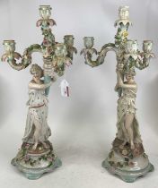 A pair of German figural porcelain table candelabra, each h.54cm