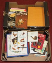 Two boxes of books relating to pipes and smoking accessories