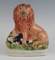A Staffordshire model of the British lion over Napoleon III, circa 1860, the lion shown with paws